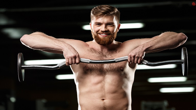 Muscular lifter performing a barbell upright row showing start and pull positions