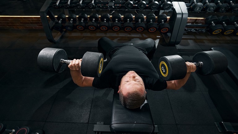 Lifter performing a dumbbell incline bench press on a 30 degree bench